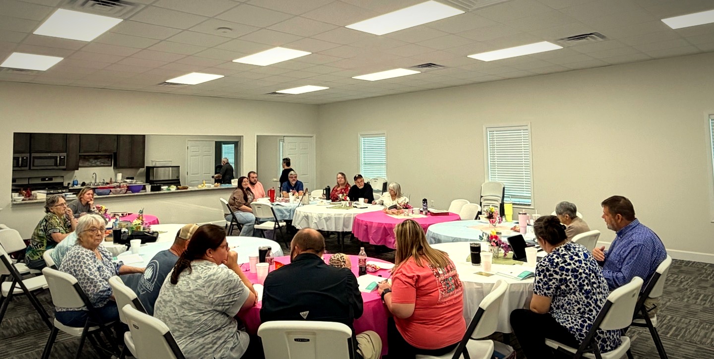 Bluewater Baptist Church family gathered for fellowship around decorated tables